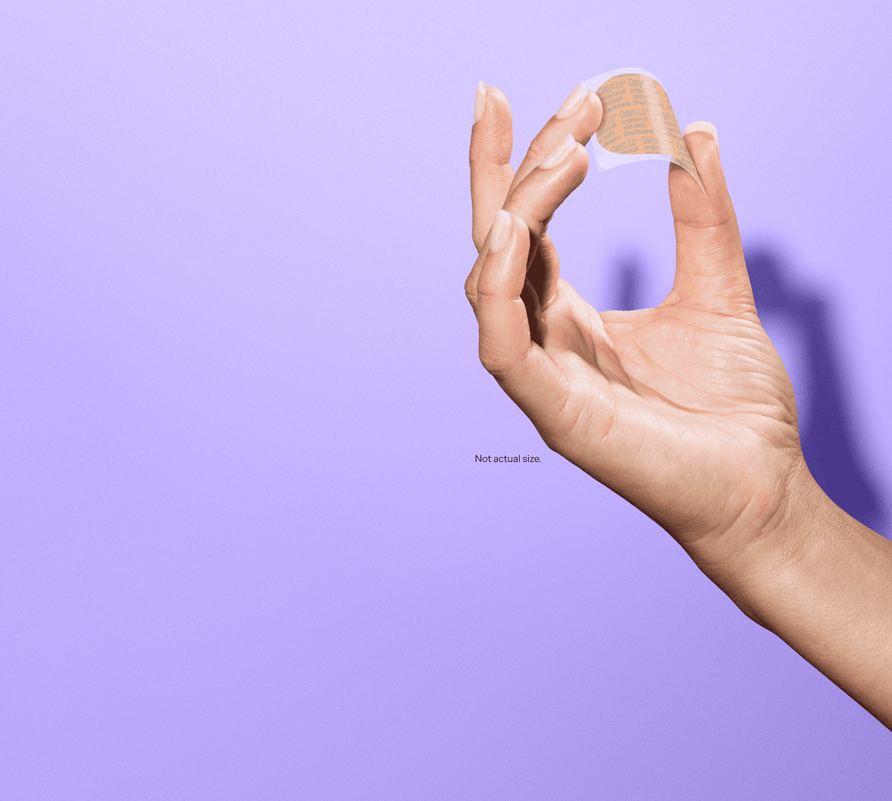 A hand holding the Gwyn Lo birth control patch