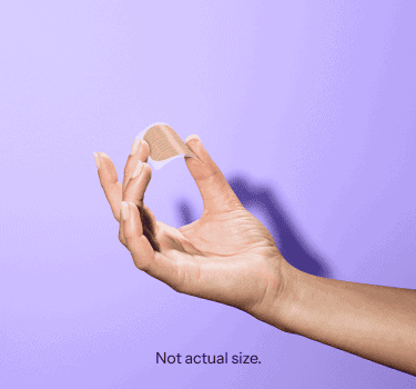 A hand holding the Gwyn Lo birth control patch